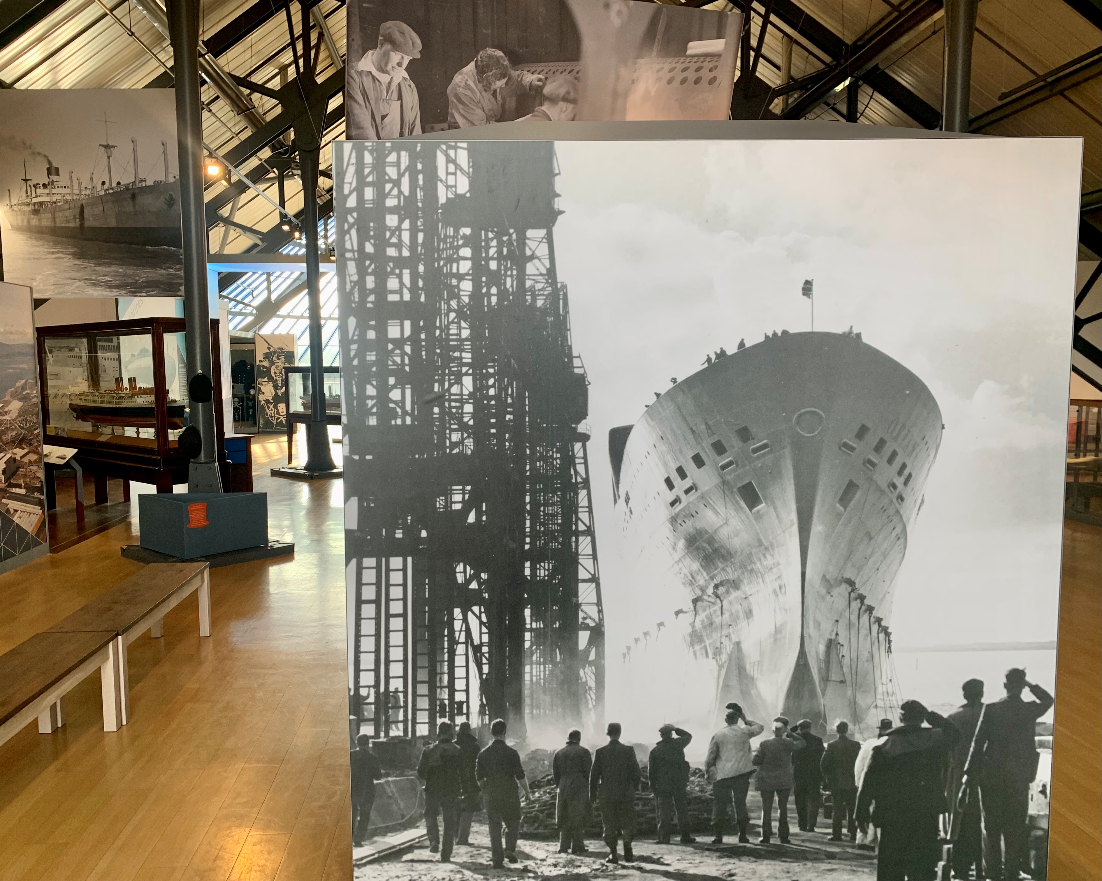 A view inside the museum showing photographs of various ships, as well as ship models