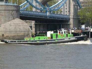 Green London sailing by Tower Bridge