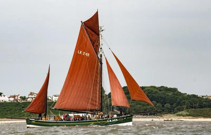 Swan under full sail, starboard side view
