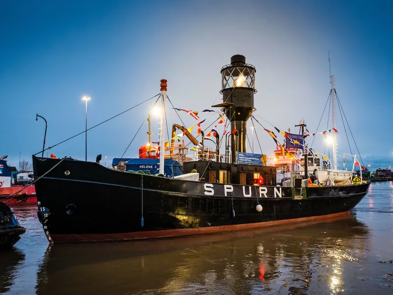 Spurn Lightship on the water at dusk with the light on, port bow view