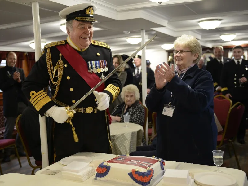 Pam Bathurst and Admiral Lord West about to cut a cake